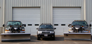 Our plow trucks lined up in the yard, ready for the next storm